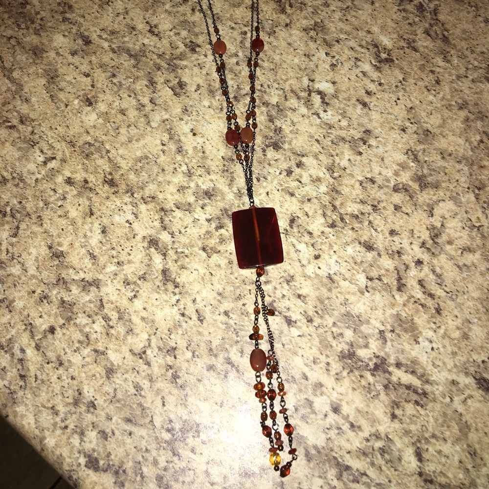 Amber color necklace.